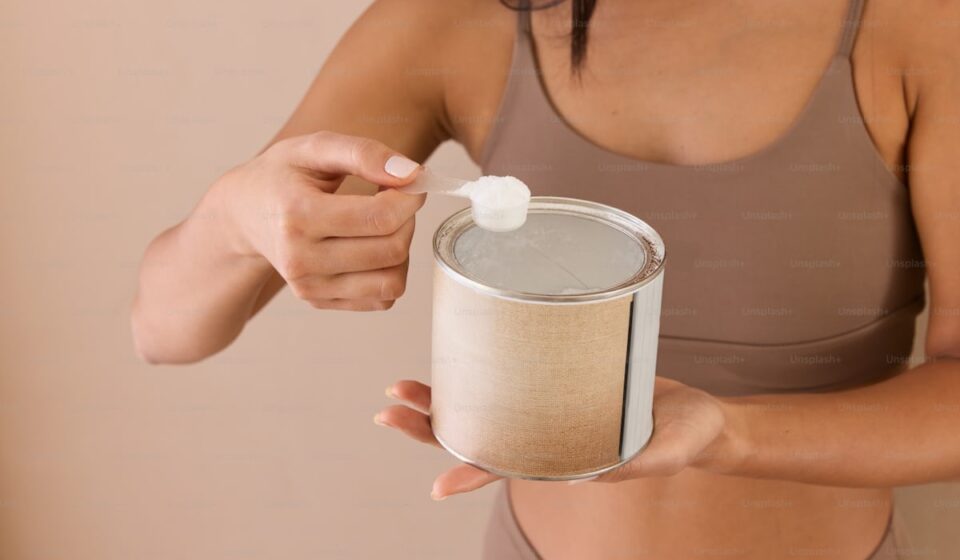 Creatine monohydrate powder with measuring scoop for daily supplementation